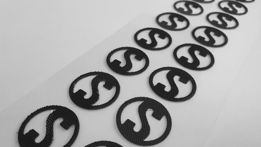 Die cut hook and loop shapes in the form of the letter S
